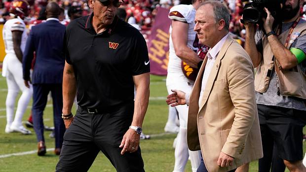 Washington Commanders head coach walks with Washington Commanders managing partner Josh Harris following the Commanders victory over the Arizona Cardinals at FedExField.