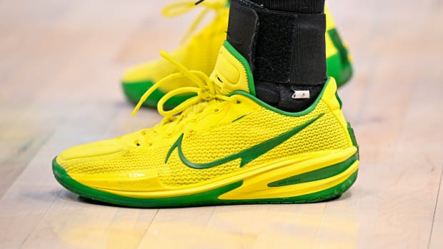 View of yellow and green Nike shoes.