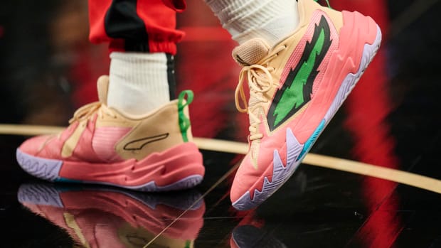 Portland Trail Blazers guard Scoot Henderson's pink and green PUMA shoes.
