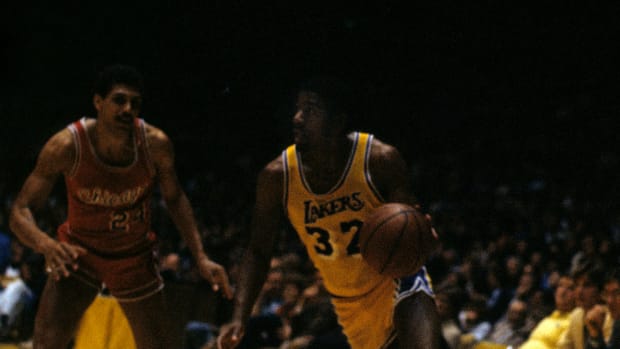 Los Angeles Lakers shooting guard Magic Johnson against Chicago Bulls shooting guard Reggie Theus