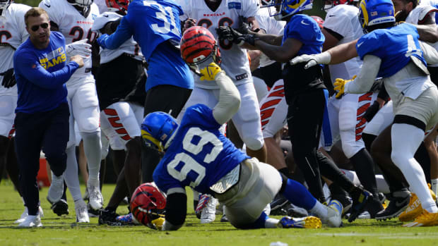 Los Angeles Rams defensive tackle Aaron Donald (99) is knocked to the ground as a third scuffle escalates into a brawl during a joint preseason camp practice between the Cincinnati Bengals and the Los Angeles Rams.