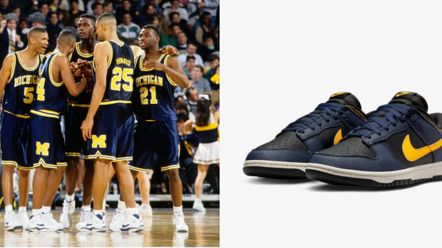 The Michigan Wolverines basketball team next to a navy Nike sneaker.