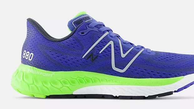 Side view of blue and green New Balance running shoe.
