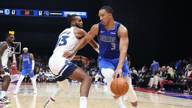 Dallas Mavericks' Grant Williams drives past a Minnesota Timberwolves defender in Abu Dhabi.