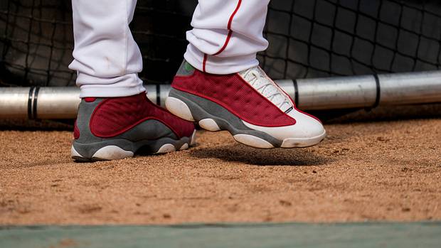 View of Elly De La Cruz's red and grey Air Jordan shoes.