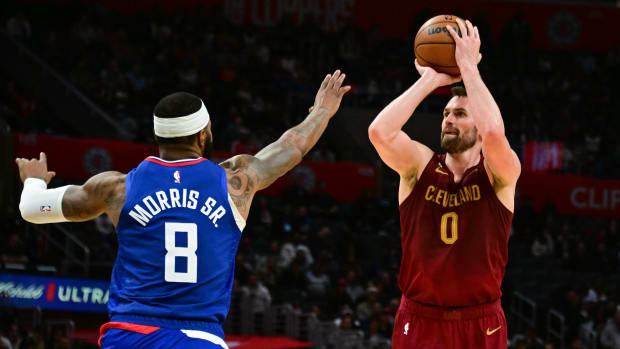 Nov 7, 2022; Los Angeles, California, USA; Cleveland Cavaliers forward Kevin Love (0) attempts a shot as Los Angeles Clippers forward Marcus Morris Sr. (8) defends in the fourth quarter at Crypto.com Arena. Mandatory Credit: Richard Mackson-USA TODAY Sports