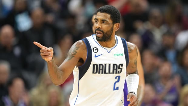 Dallas Mavericks guard Kyrie Irving points to a teammate during a game.
