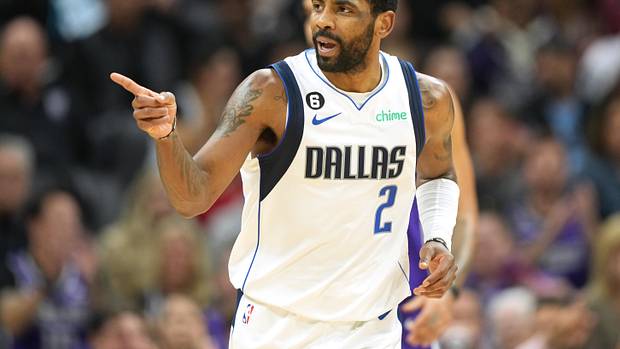 Dallas Mavericks guard Kyrie Irving points to a teammate during a game.