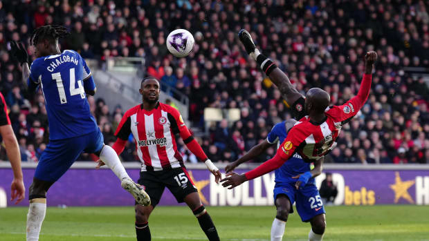 Yoane Wissa pictured (right) in mid-air shooting with a bicycle kick to score a stunning goal for Brentford in a 2-2 draw against Chelsea in March 2024