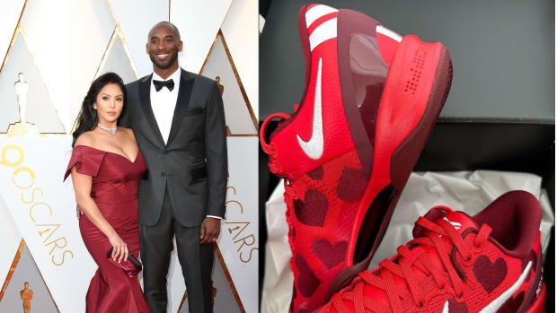Kobe and Vanessa Bryant are next to red Nike sneakers.