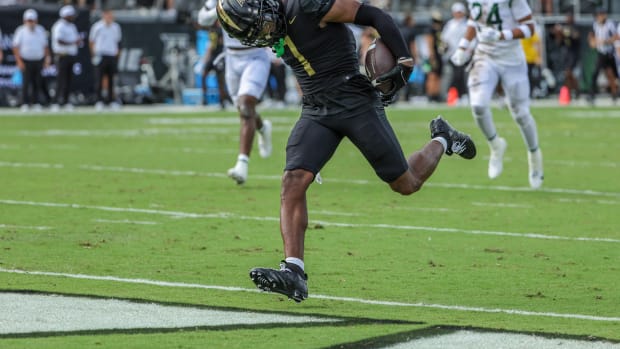 Sep 30, 2023; Orlando, Florida, USA; UCF Knights wide receiver Javon Baker (1) scores a touchdown during the first quarter against the Baylor Bears at FBC Mortgage Stadium. Mandatory Credit: Mike Watters-USA TODAY Sports  