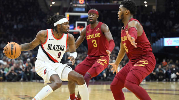 Nov 30, 2023; Cleveland, Ohio, USA; Cleveland Cavaliers guard Caris LeVert (3) and guard Donovan Mitchell (45) defend Portland Trail Blazers forward Jerami Grant (9) in the second quarter at Rocket Mortgage FieldHouse.