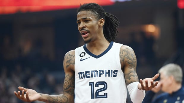 Memphis Grizzlies guard Ja Morant questions a foul call during a game.