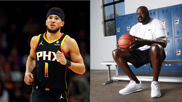 Devin Booker next to Shaquille O'Neal.
