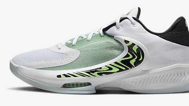 Side view of a green and white Nike basketball shoe.