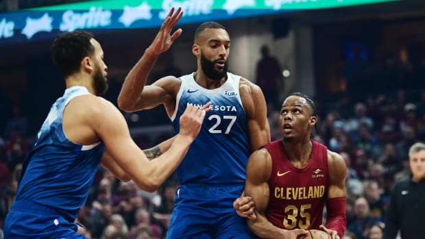 Mar 8, 2024; Cleveland, Ohio, USA; Cleveland Cavaliers forward Isaac Okoro (35) drives to the basket against Minnesota Timberwolves center Rudy Gobert (27) during the first half at Rocket Mortgage FieldHouse. Mandatory Credit: Ken Blaze-USA TODAY Sports  