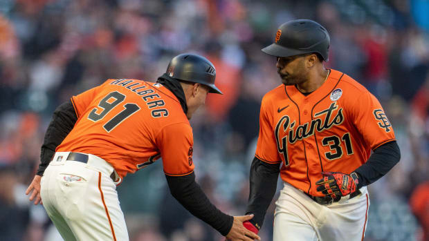 SF Giants first baseman LaMonte Wade Jr. (31) high fives San Francisco Giants third base coach Mark Hallberg (91) after hitting a solo home run against the Baltimore Orioles on June 2nd, 2023.