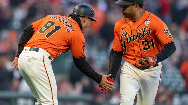 SF Giants first baseman LaMonte Wade Jr. (31) high fives San Francisco Giants third base coach Mark Hallberg (91) after hitting a solo home run against the Baltimore Orioles on June 2nd, 2023.