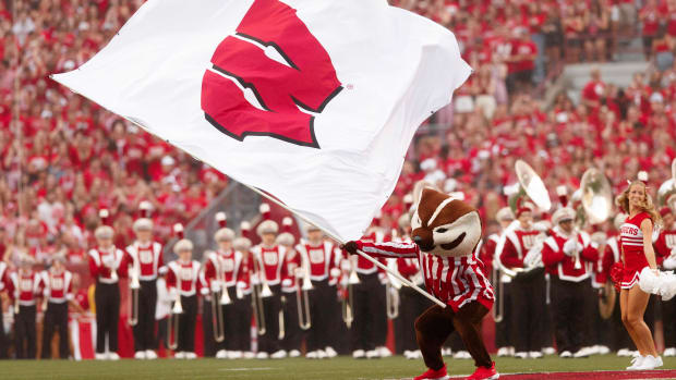Bucky Badger waves a Wisconsin flag in pregame.