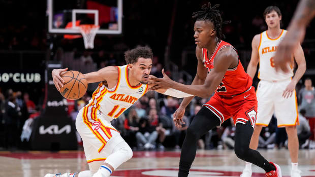 Hawks guard Trae Young is defended by Bulls guard Ayo Dosunmu.