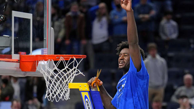 Duke Blue Devils forward AJ Griffin (21) holds a piece of the net as they celebrate their win over the Arkansas Razorbacks in the finals of the West regional of the men's college basketball NCAA Tournament at Chase Center.