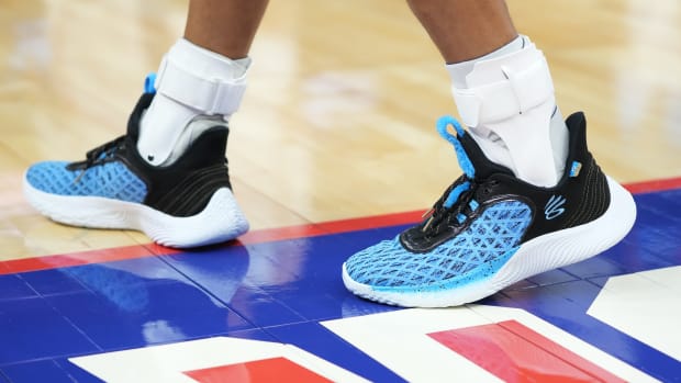 Golden State Warriors point guard Stephen Curry wearing the Sesame Street x Curry Flow 9 'Cookie Monster'.