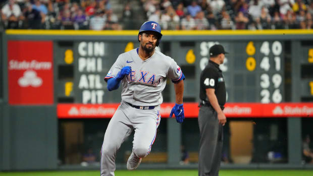 Aug 23, 2022; Denver, Colorado, USA; Texas Rangers second baseman Marcus Semien (2) runs to third base on an RBI triple in the fifth inning against the Colorado Rockies at Coors Field. Mandatory Credit: Ron Chenoy-USA TODAY Sports