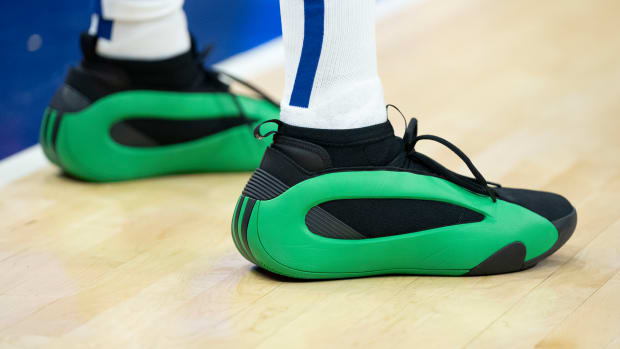 Los Angeles Clippers guard James Harden's green and black adidas sneakers.