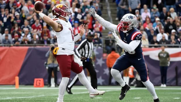 Washington Commanders quarterback Sam Howell (left) throws a pass against the New England Patriots (right).