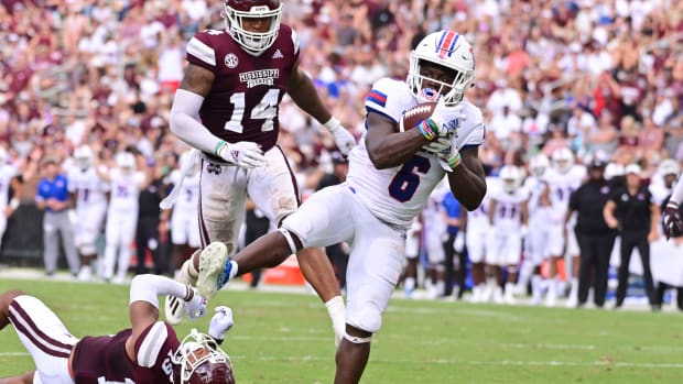 Louisiana Tech Bulldogs wide receiver Smoke Harris (6) breaks the tackle of Mississippi State Bulldogs safety Collin Duncan (19) during the second quarter at Davis Wade Stadium at Scott Field.