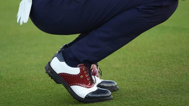 Side view of Justin Thomas' white and navy FootJoy golf shoes.