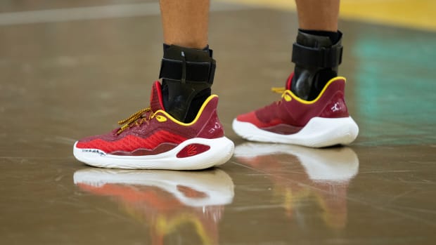 Golden State Warriors guard Stephen Curry's red and gold Under Armour sneakers.