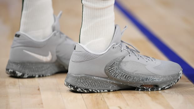 View of Giannis Antetokounmpo's grey Nike shoes.