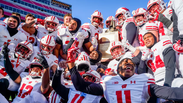 Wisconsin players celebrate with the Freedom Trophy after a win at Nebraska.