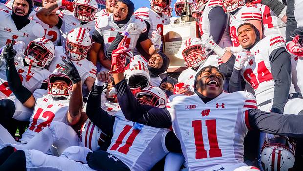 Wisconsin players celebrate with the Freedom Trophy after a win at Nebraska.