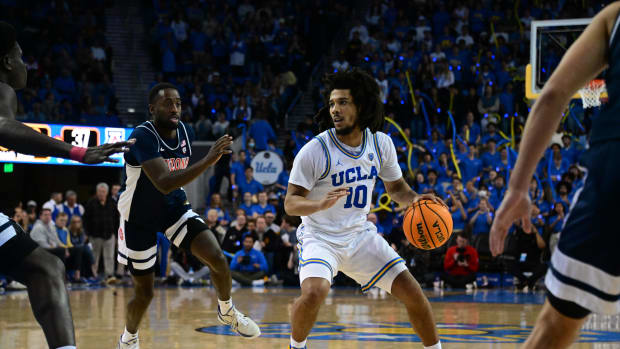 UCLA Bruins guard Tyger Campbell dribbles the ball against the Arizona Wildcats defense.
