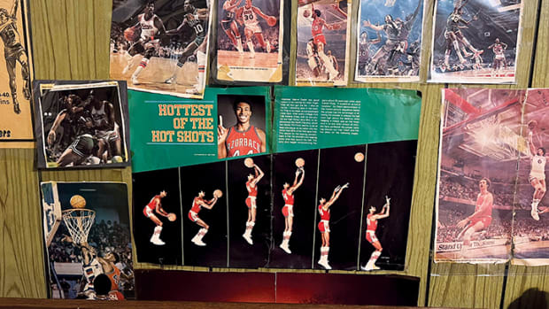 Former Arkansas assistant coach Matt Zimmerman's childhood wall featuring several basketball articles and a spread of former Razorback basketball star Marvin Delph.