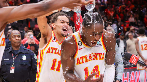 Hawks guard Trae Young dumps water on forward AJ Griffin.