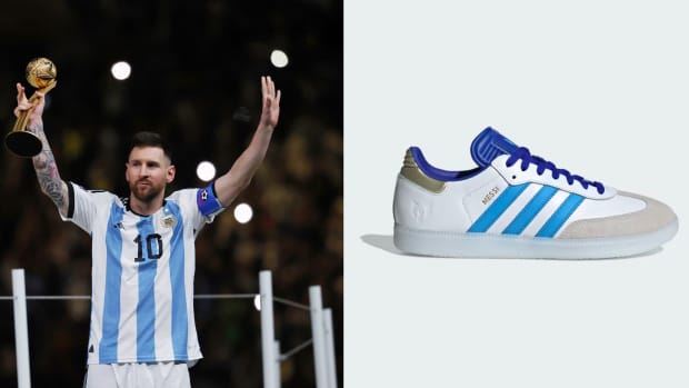 Argentina forward Lionel Messi next to his white and blue adidas sneakers.