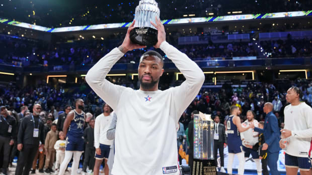 Damian Lillard holds up the MVP trophy after the NBA All-Star Game.