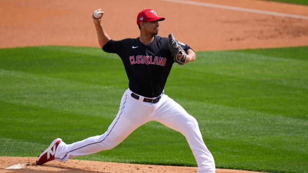 Cleveland Guardians pitcher Carlos Carrasco delivers a pitch in the first inning during a MLB spring training baseball game against the Cincinnati Reds, Saturday, Feb. 24, 2024, at Goodyear Ballpark in Goodyear, Ariz.