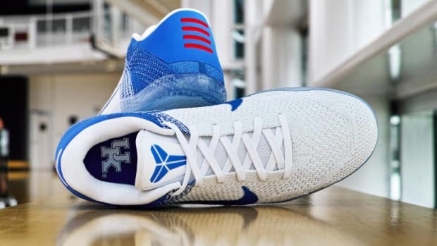 Side view of Kentucky-branded Nike Kobe shoes.
