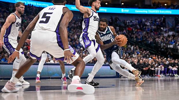 The Sacramento Kings defense swarms to Dallas Mavericks star Kyrie Irving.