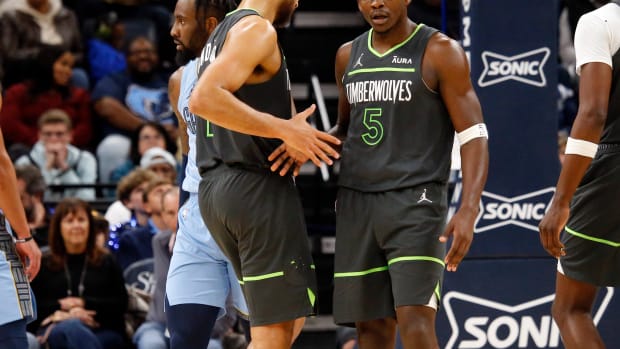 Minnesota Timberwolves guard Anthony Edwards (5) reacts with forward-guard Kyle Anderson (1) during the second half against the Memphis Grizzlies at FedExForum in Memphis, Tenn., on Nov. 26, 2023.