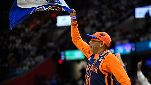 Spike Lee waves a towel during a Knicks game.