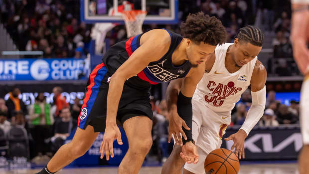 Dec 2, 2023; Detroit, Michigan, USA; Detroit Pistons guard Cade Cunningham (2) battles for the ball with Cleveland Cavaliers forward Isaac Okoro (35) during the second half at Little Caesars Arena.