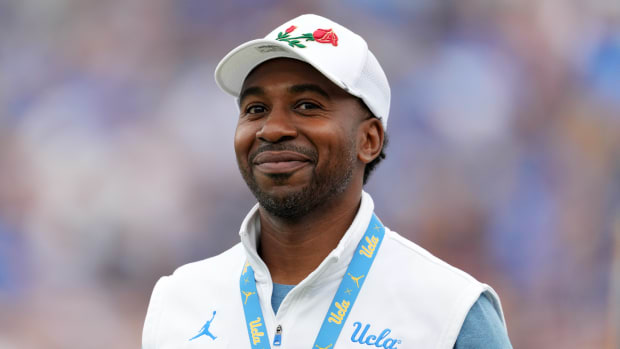 UCLA Bruins athletic director Martin Jarmond smiles during a football game.