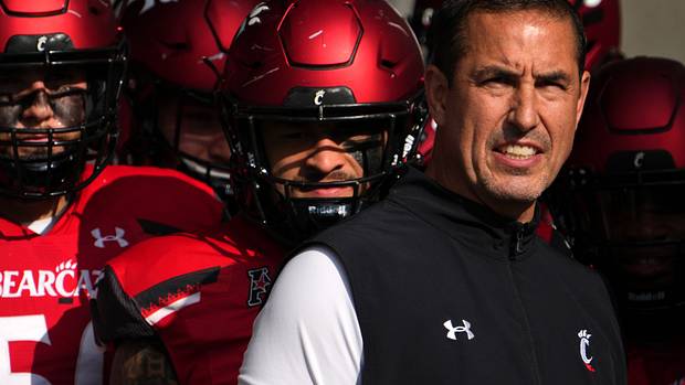 Cincinnati head coach Luke Fickell standing with his team before running onto the field.