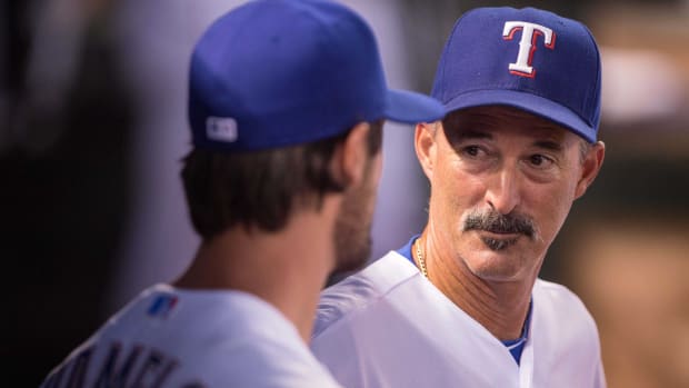 Jul 31, 2015; Arlington, TX, USA; Texas Rangers pitching coach Mike Maddux (31) talks with starting pitcher Cole Hamels (35) during the game at Globe Life Park in Arlington. The Rangers defeated the Giants 6-3. Mandatory Credit: Jerome Miron-USA TODAY Sports