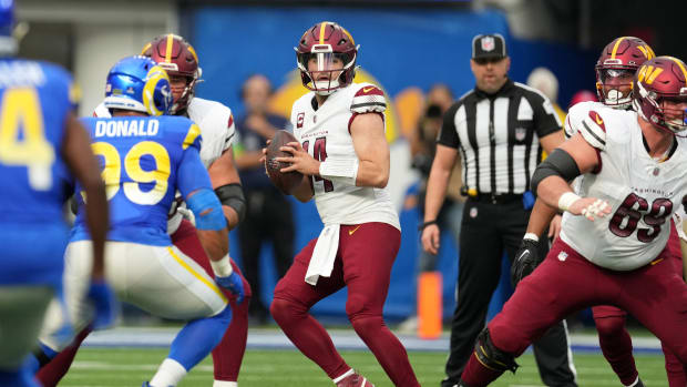 Washington Commanders quarterback Sam Howell (14) throws the ball against the Los Angeles Rams in the first half at SoFi Stadium.